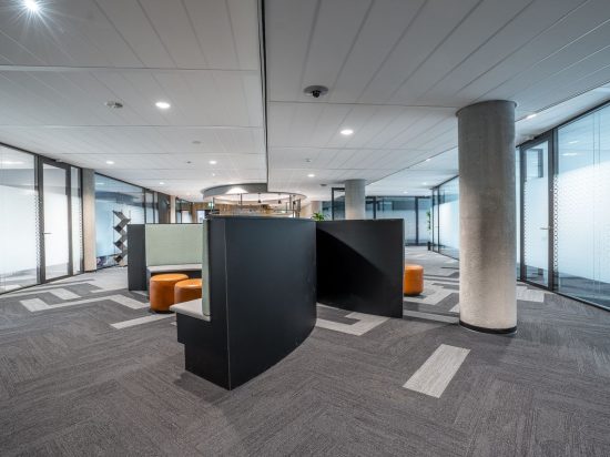 Spacious modern office interior featuring contemporary furniture and open workspace.